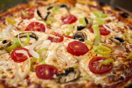 Delicious pizza with vegetables on the tableの写真素材