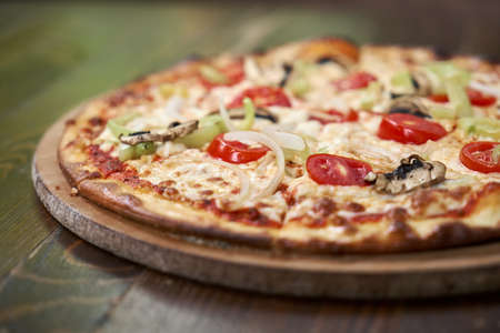 Delicious pizza with vegetables on the tableの写真素材