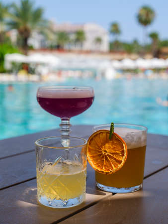 colorful and delicious cocktails in a hotel poolの写真素材