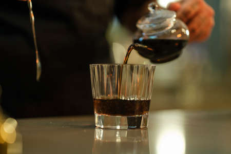 a fresh black coffee prepared by the baristaの写真素材