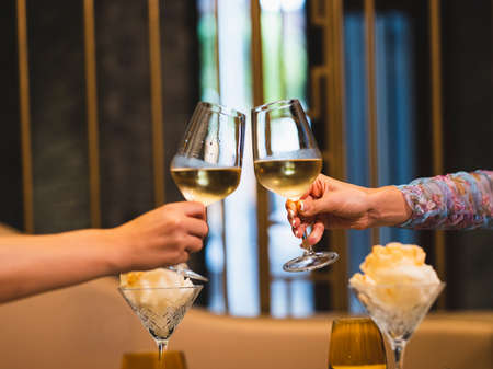couple celebrating with white wineの写真素材