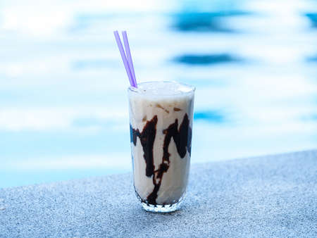 cold coffee by the poolの写真素材