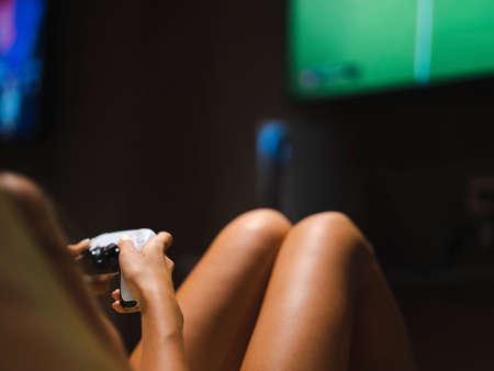a young girl playing a game on a game console