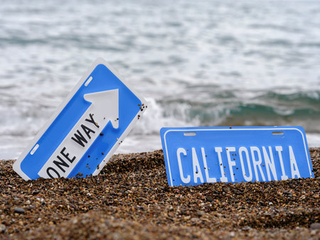 one way and California sign on the beachの写真素材