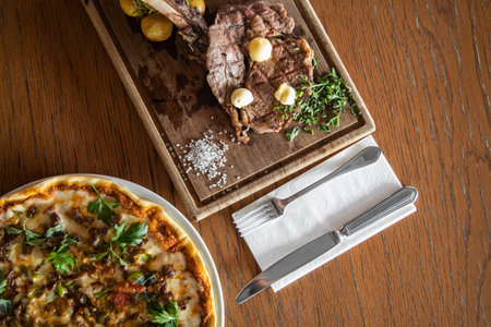 Italian pizza and steak for dinnerの写真素材