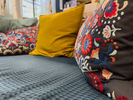 decorative pillows and bed in the bedroomの写真素材
