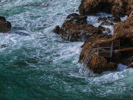 beautiful waves crashing on rocksの写真素材