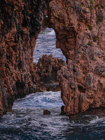 beautiful waves crashing on rocksの写真素材
