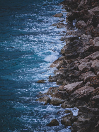 beautiful waves crashing on rocksの写真素材
