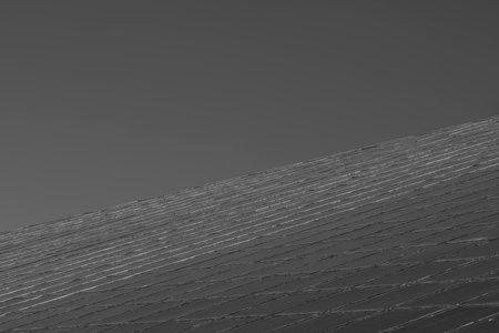 Symmetrical glass windows of a buildingの写真素材