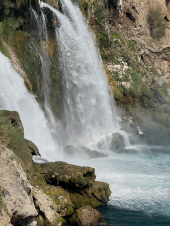 waterfall cascading into blue waterの写真素材
