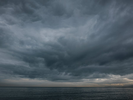 Moody sky with rain clouds over seascape