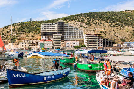 Balaklava(Balaclava), Sevastopol, Crimea, Russia - September 13, 2018: Black Sea. Harbor in the bay of Balaklava. Yachts and boats on the background of the embankment with old and modern buildings.のeditorial素材
