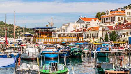 Balaklava(Balaclava), Sevastopol, Crimea, Russia - September 13, 2018: Black Sea. Harbor in the bay of Balaklava. Yachts and boats on the background of the embankment with old and modern buildings.のeditorial素材