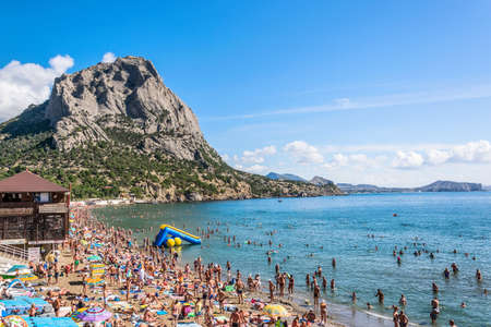Novy Svet (New World), Sudak, Republic of Crimea - September 11, 2018: A crowded beach in the Green Bay near Mount Sokol. Black Sea.のeditorial素材