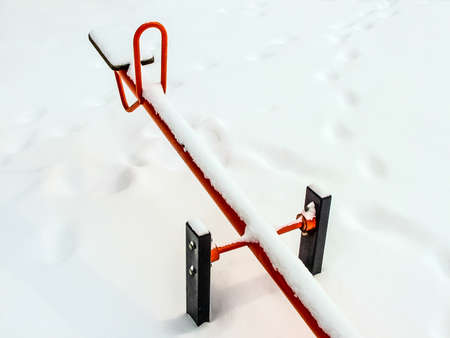 Winter. Playground. Swings sprinkled with snowの写真素材