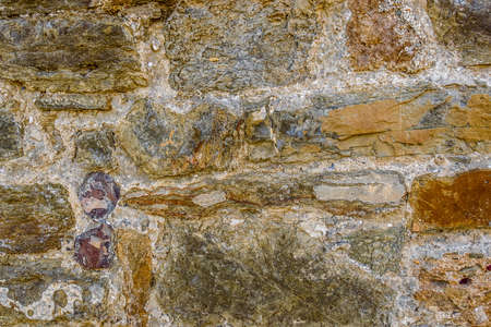 Fragment of the outer wall of the ancient Genoese fortress (7th century AD) from multicolored stones. City Sudak. Republic of Crimeaの写真素材
