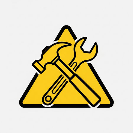 a yellow triangle sign with a hammer and wrench crossed in the middle.の素材