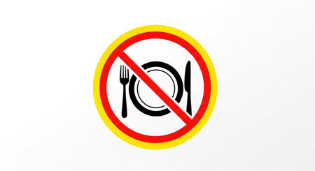 a circular sign with a red line through a plate, fork, and knife, indicating no food or eating allowed.の素材
