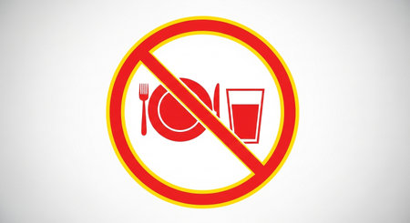 a red and yellow no food and drink sign with a plate, fork, knife, and glass crossed out in a circleの素材