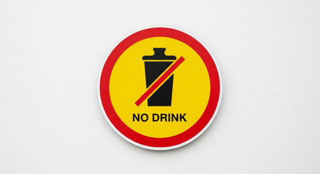 a yellow circle with a red border and a black crossed-out cup indicates that drinks are not allowed here.の素材
