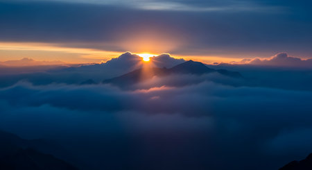 beautiful sunrise over the mountains with clouds and fog creating a serene landscapeの素材