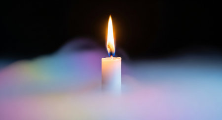 Candle light on a black background. Close-up shot.の素材