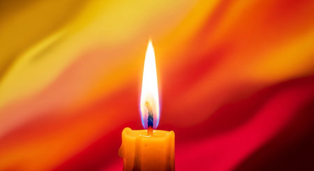 Burning candle on a colorful background. Shallow depth of field.の素材