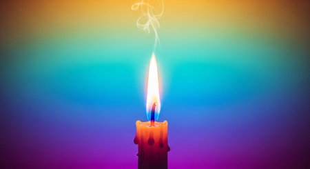Burning candle on a multicolored background, close-upの素材
