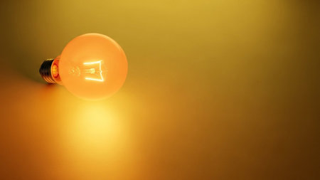 Light bulb on yellow background with copy space. 3D rendering.の素材