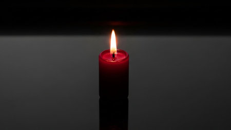 Candle flame on a black background, close-up, selective focusの素材