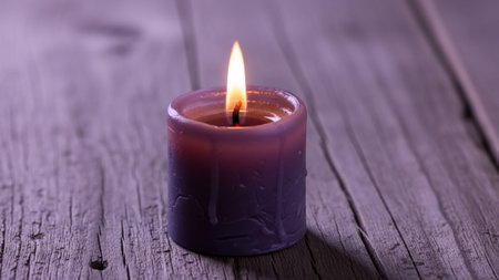 Burning candle on a wooden background, close-up, selective focusの素材