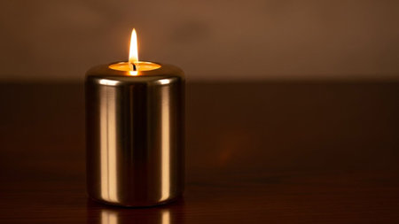 candle on wooden table with shallow depth of field and bokehの素材