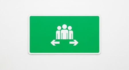 Green sign on a white wall with an arrow pointing to the rightの素材