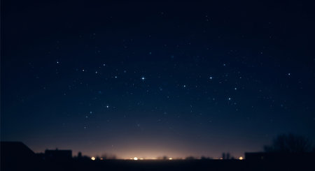 Night sky with stars and the silhouette of a city in the foregroundの素材