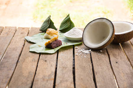 Dessert from banana leave thai style Kaow-neaw-sang-kha-ya on old wooden background outdoor.Dessert original of thai.の写真素材