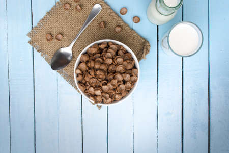 Cereal food and milk bottle and milk glass  on wooden sky blue table.Meal or breakfast hi-vitamin and calcium.の写真素材