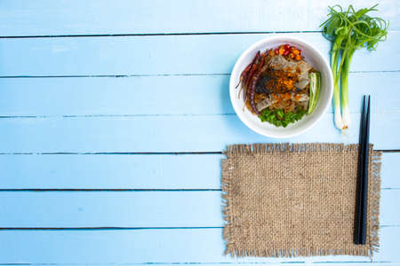 Noodles in Thailand Beef noodle on wooden sky blue table.top viewの写真素材