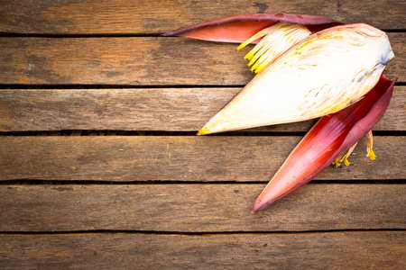 Banana blossom on wooden background.Raw food or background food.の写真素材