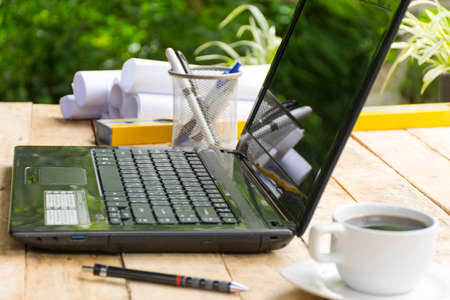Desktop with level  and equipment for architect on wooden table with outdoor view.Beside and close up.の写真素材