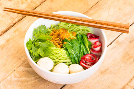 Noodles in Thailand Ba-Mee-Moo-Dang  or pasta of Asia on wooden table.Close up and top view.