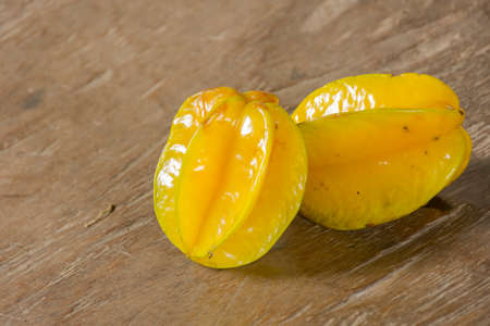 Carambola on wooden table.Fruit for health.Close up.の写真素材