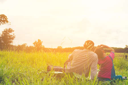 Family with mountain view,Or Father and son are happy with travel and picnic with mountain and sunshine view.の写真素材
