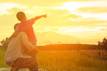 Family with mountain view,Or Father and son are happy with travel and picnic with mountain and sunshine view.の写真素材