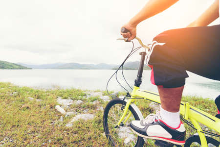 Man Asian ride a bicycle and lake view.の写真素材