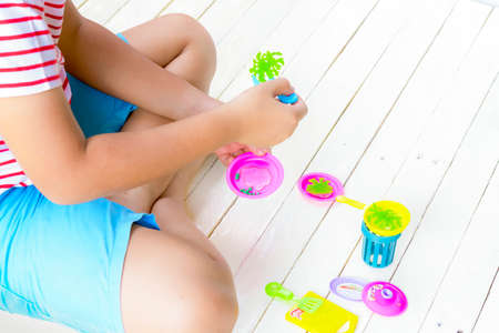 Child Asian playing toy on white wooden.Top view.の写真素材