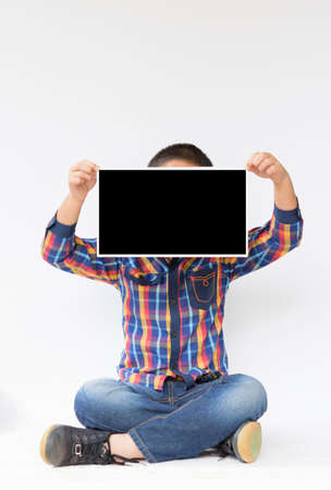 Child with blank or mock up in his hands on isolated.