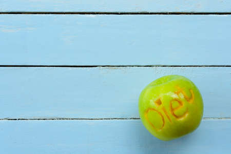 Apple carving character diet on blue background.Top view.の写真素材