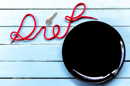 Background of diet concept,black dish and diet alphabet.の写真素材