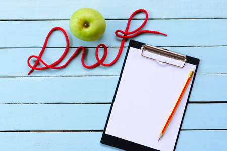 Concept diet,Green apple and clipboard and diet alphabet.の写真素材